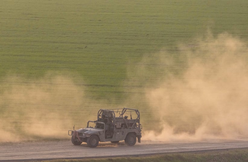  A MILITARY vehicle patrols near the Israeli border with the Gaza Strip, on the first day of 2024. It certainly wasn't the best of times, but 2023 could could go down as the worst, especially if you lived in Israel, says the writer. (photo credit: Chaim Goldberg/Flash90)