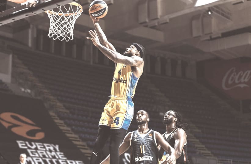 MACCABI TEL AVIV’S Lorenzon Brown goes to the hoops for two of his 12 points in the yellow-and-blue’s 93-83 victory over Monaco in Euroleague action on Tuesday night. Maccabi plays tonight against Turkish side Fenerbahce in Lithuania. (photo credit: Dragan Tesic and Djordje Kostic/Courtesy)