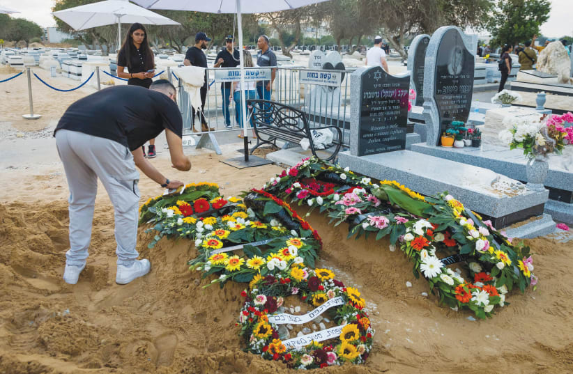 THE GRAVES of Israelis Shay Silas Nigreke and his son Aviad Nir, who were murdered by terrorists in Huwara last August.  (photo credit: FLASH90)