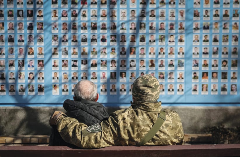  PAYING TRIBUTE to fallen Ukrainian servicemen at the Wall of Remembrance. (photo credit: GLEB GARANICH/REUTERS)