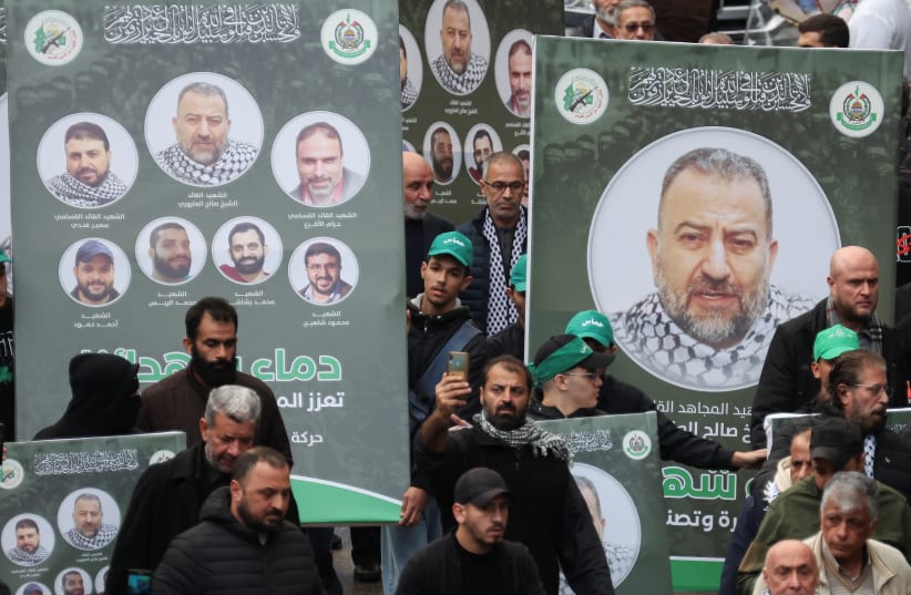    People carry placards with pictures of deputy head of Hamas, Saleh al-Arouri, who was killed by what Lebanese and Palestinian security sources say was a drone strike by Israel, as mourners gather during his funeral in Beirut, Lebanon January 4, 2024.  (photo credit: REUTERS/MOHAMED AZAKIR)