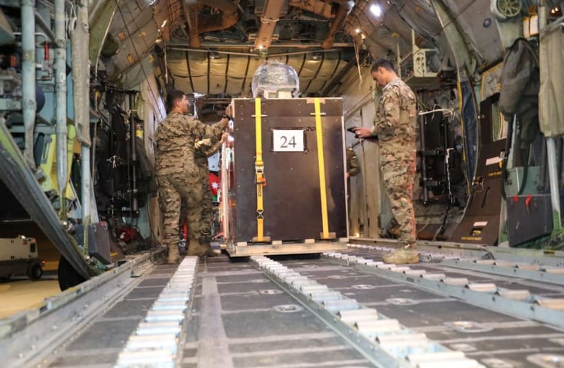  A picture released on December 24, 2023 by the Jordanian Armed Forces website shows members of the Jordanian military load what it said to be humanitarian aid into a plane to be airdropped to a church in Gaza on Christmas Eve, in Zarqa, Jordan. (photo credit: Jordanian Armed Forces/Handout via REUTERS)