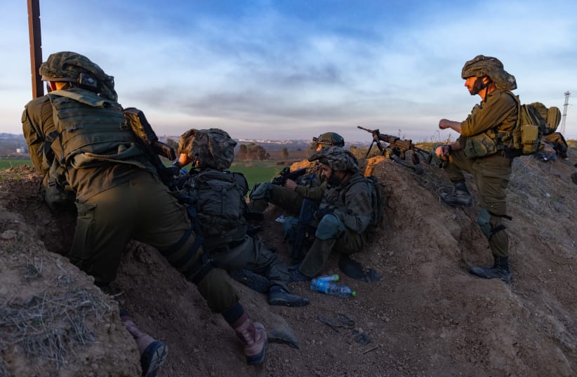  Israeli soldiers take position near the border fence with the Gaza Strip, southern Israel, on January 7, 2024. (photo credit: CHAIM GOLDBEG/FLASH90)