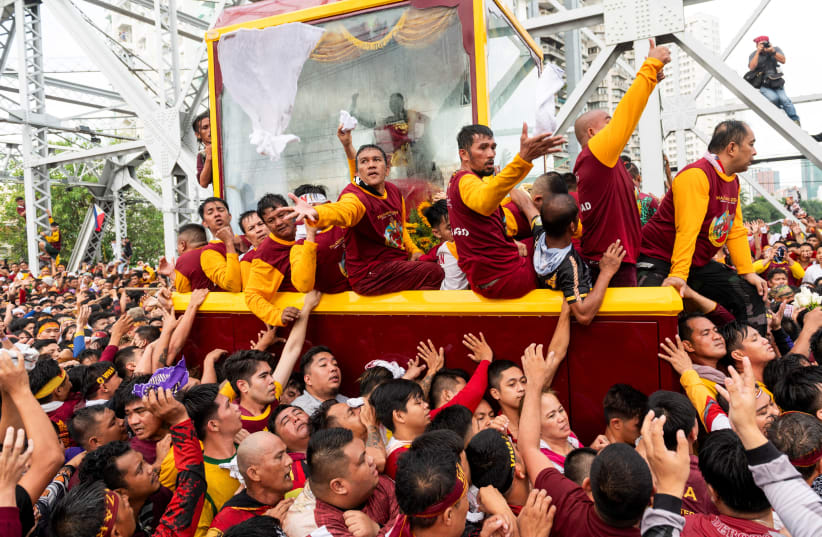  Filipino devotees join the annual Catholic procession of the Black Nazarene during its feast day in Manila, Philippines, January 9, 2024 (photo credit: REUTERS/LISA MARIE DAVID)