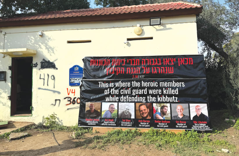 HANGING ON a simple red-roofed building, a sign picturing seven kibbutzniks proclaims: 'This is where the heroic members of the civil guard were killed while defending the kibbutz.' (photo credit: GIL TROY)