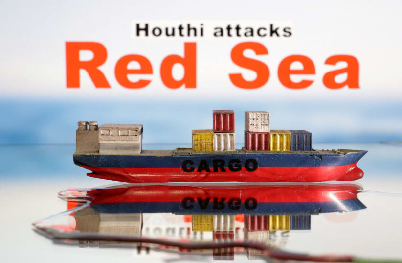  A cargo ship boat model is seen in front of "Red Sea" and "Houthi attacks" words in this illustration taken January 9, 2024. (photo credit: REUTERS/DADO RUVIC/ILLUSTRATION)