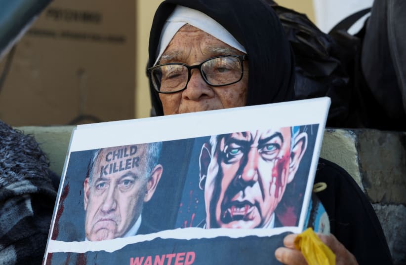  A woman holds a placard during an interfaith prayer service in Bo-Kaap for the success of the South African Government's genocide case, which accuses Israel of genocide in the Gaza war, at the International Court of Justice in the Hague, in Cape Town, South Africa, January 10, 2024 (photo credit: REUTERS/ESA ALEXANDER)