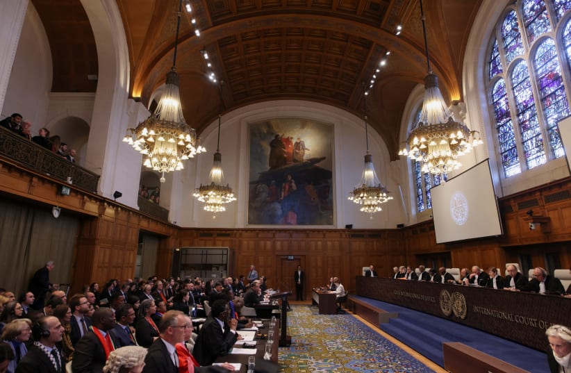 People sit inside the International Court of Justice (ICJ) on the day of the trial to hear a request for emergency measures by South Africa, who asked the court to order Israel to stop its military actions in Gaza, The Hague, Netherlands, January 11, 2024 (photo credit: REUTERS/THILO SCHMUELGEN)
