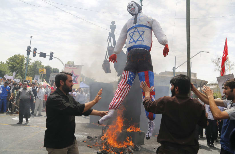  Burning an Israeli, American, and British effigy in Tehran, 2016 (photo credit: Atta Kenare/AFP via Getty Images)