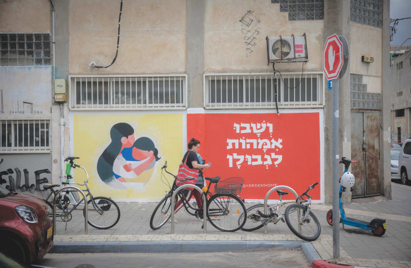  WALL MURALS in Florentin. Tel Aviv has taken in over 20,000 evacuees from the South and North. (photo credit: MIRIAM ALSTER/FLASH90)