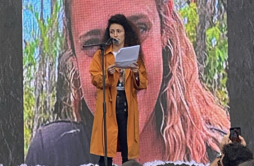  Yarden Gonen speaks in front of a picture of her sister, Romi Gonen, kidnapped on October 7 and held captive by Hamas in Gaza. (photo credit: Aaron Poris/The Media Line)
