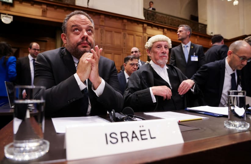  Legal adviser to Israel's Foreign Ministry Tal Becker and British jurist Malcolm Shaw sit inside the International Court of Justice (ICJ) as judges hear a request for emergency measures to order Israel to stop its military actions in Gaza, in The Hague, Netherlands January 12, 2024 (photo credit: REUTERS/THILO SCHMUELGEN)