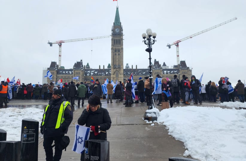  Demonstrators holding Israeli flags converge on Parliament Hill for a rally in Ottawa, Ontario, Canada December 4, 2023.  (photo credit: REUTERS/Ismail Shakil)