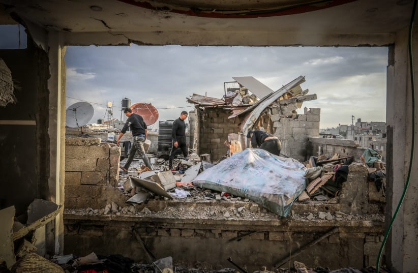  Palestinians at the site of a destroyed building from an Israeli air strike in Rafah, in the southern Gaza Strip, on January 14, 2024 (photo credit: ABED RAHIM KHATIB/FLASH90)