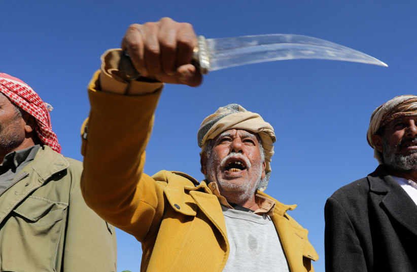  A tribal supporter of Yemen's Houthis hold his traditional dagger, or jambiya, during a protest against recent U.S.-led strikes on Houthi targets, near Sanaa, Yemen January 14, 2024 (photo credit: REUTERS/Khaled Abdullah TPX IMAGES OF THE DAY)