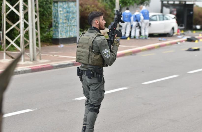  A Border Police officer at the scene of the terror attack in Ra'anana. January 15, 2024. (photo credit: AVSHALOM SASSONI)