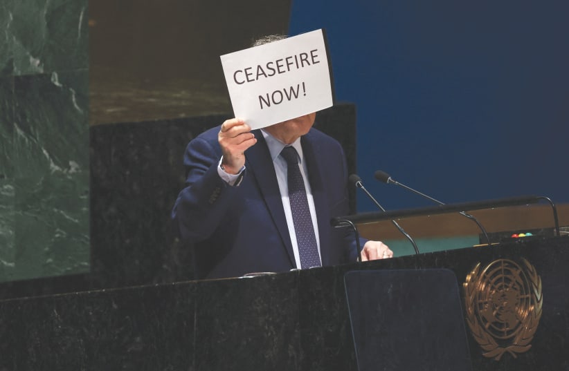  PALESTINIAN UN envoy Riyad Mansour holds up a sign calling for an immediate ceasefire in Gaza, as he speaks in the General Assembly Hall at UN headquarters in New York City, last week. The UN is losing its relevance fast, the writers argue. (photo credit: Shannon Stapleton/Reuters)