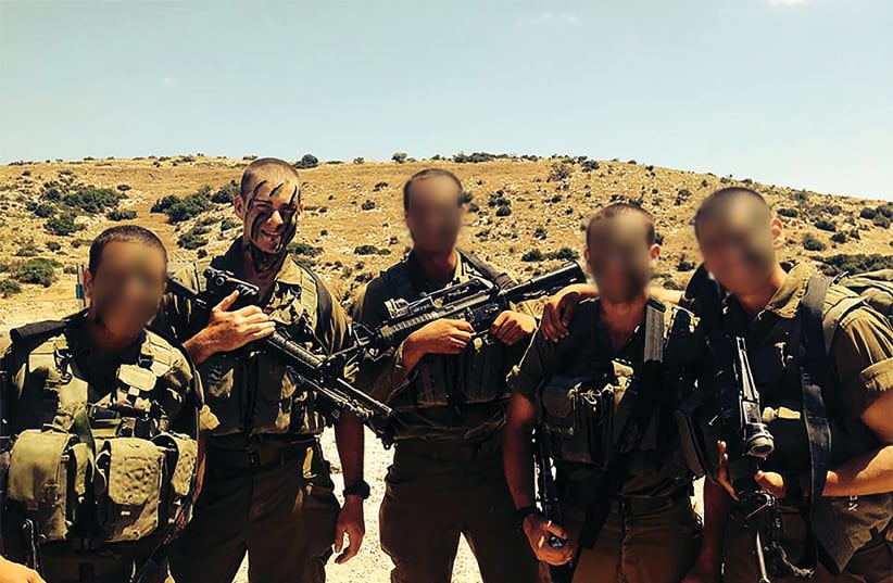  THE WRITER, second from left, poses with squadmates during a military training exercise in June 2014. (photo credit: Raphael Benchabbat)