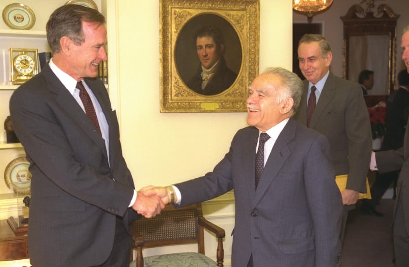  YITZHAK SHAMIR (center), accompanied by ambassador Zalman Shoval, is greeted by then-US president George H.W. Bush in the White House, in 1990. (photo credit: TSVIKA ISRAELI/ GPO)