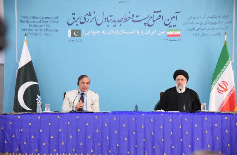  Pakistan's Prime Minister Shehbaz Sharif, and Iran's President Ebrahim Raisi speak during a Joint Inauguration of the Polan-Gabd Electricity Transmission Line, at Mand-Pishin border crossing point, in Pishin, Pakistan May 18, 2023. (photo credit: Press Information Department (PID)/Handout via REUTERS)