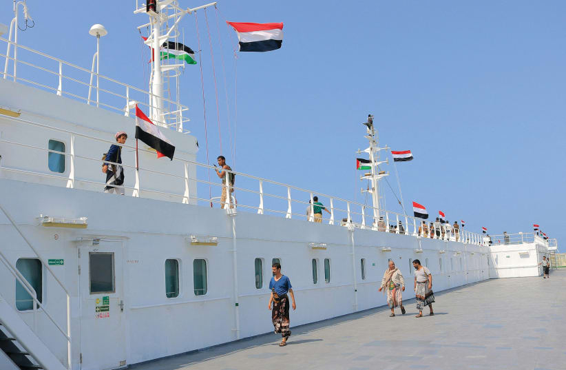  HOUTHI REBELS aboard the ‘Galaxy Leader’ provide a Nov. 22 tour of this  Bahamas-flagged, British- owned cargo ship, seized  two days earlier. The vessel, docked in a port on the Red Sea in the Yemeni province of Hodeida, flew Palestinian and Yemeni flags. (photo credit: AFP VIA GETTY IMAGES)