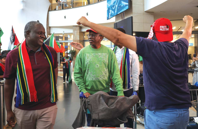  A MAN wearing a 'Free Palestine' cap welcomes members of the South African legal team against Israel at the ICJ after their return home, at the airport in Johannesburg, earlier this week. (photo credit: Alet Pretorius/Reuters)