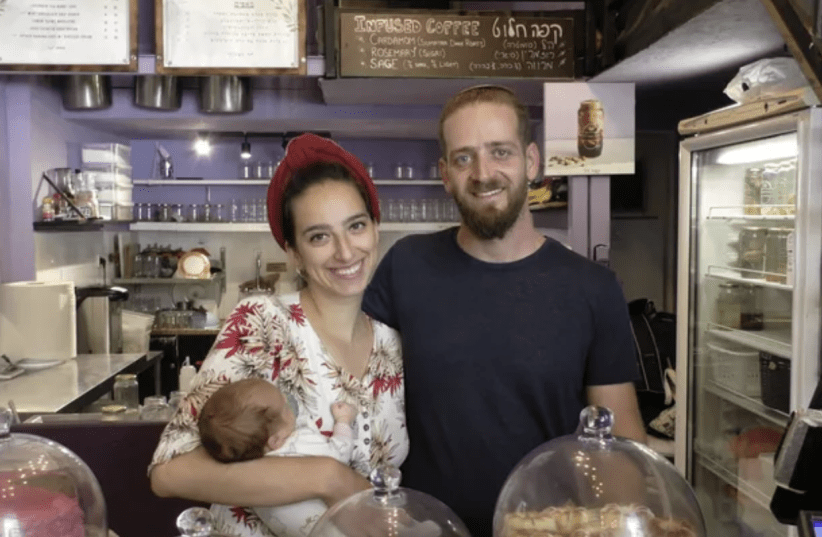  Infused JLM owners Maor and Diana Shapira, with their newborn daughter, in their shop. (photo credit: Courtesy Infused JLM)