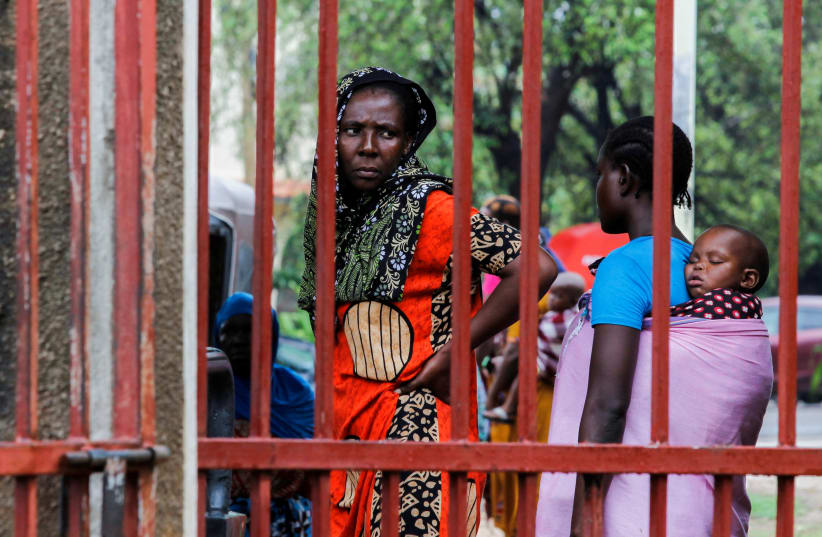  Relatives of followers of a Christian cult named as Good News International Church, who believed they would go to heaven if they starved themselves to death in Shakahola, stand outside the steel gate of the Malindi sub district hospital mortuary in Malindi, Kilifi county, Kenya April 27, 2023. (photo credit: REUTERS)