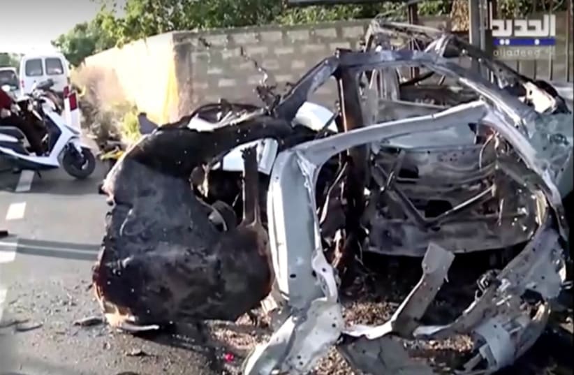  The remains of a destroyed vehicle hit during an Israeli strike lie on a road near Bazouriye, Lebanon January 20, 2024, as seen in this screen grab taken from a handout video (photo credit: AL JADEED/HANDOUT VIA REUTERS)