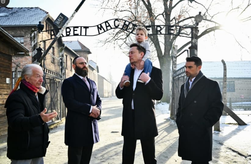 Businessman Elon Musk, third from right, and US political commentator Ben Shapiro, furthest right, visit the site of the Auschwitz-Birkenau death and concentration camp. (photo credit: YOAV DODKOVITZ)