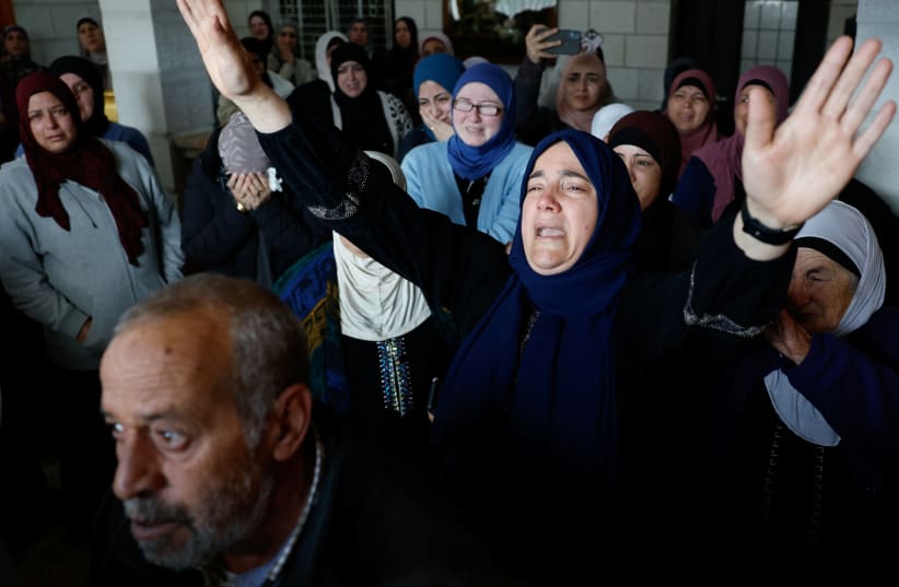  Mourners react during the funeral of American-Palestinian Tawfiq Ajjaq, 17, who according to Palestinian officials was killed by the Israeli security forces, near Ramallah in the West Bank, January 20, 2024. (photo credit: REUTERS/Mohammed Torokman)