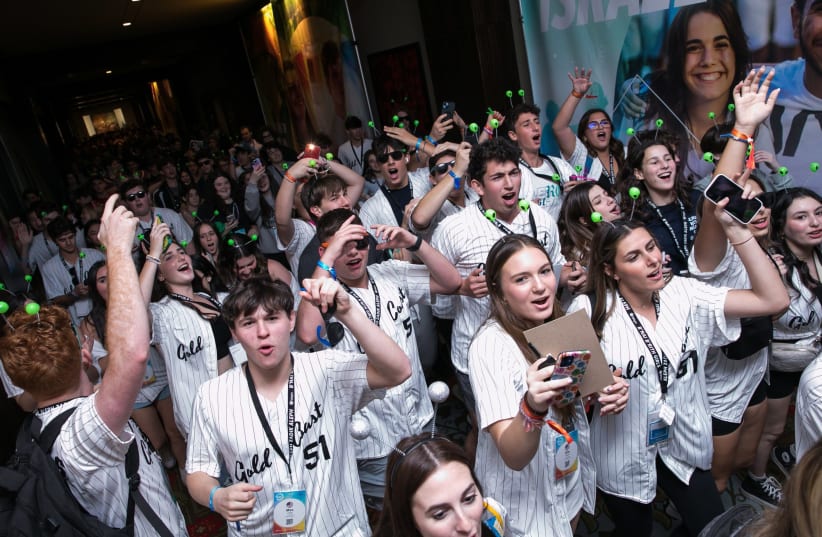  Teens from South Florida's Gold Coast Region enter the open ceremony at BBYO's 2023 International Convention in Dallas, February 2023. (photo credit: JTA/JASON DIXON PHOTOGRAPHY)