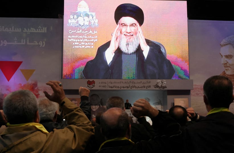   Lebanon's Hezbollah leader Sayyed Hassan Nasrallah addresses his supporters through a screen during a ceremony to mark the fourth anniversary of the killing of senior Iranian military commander General Qassem Soleimani in a U.S. attack, in Beirut's southern suburbs, Lebanon January 3, 2024.  (photo credit:  REUTERS/Mohamed Azakir/File Photo)