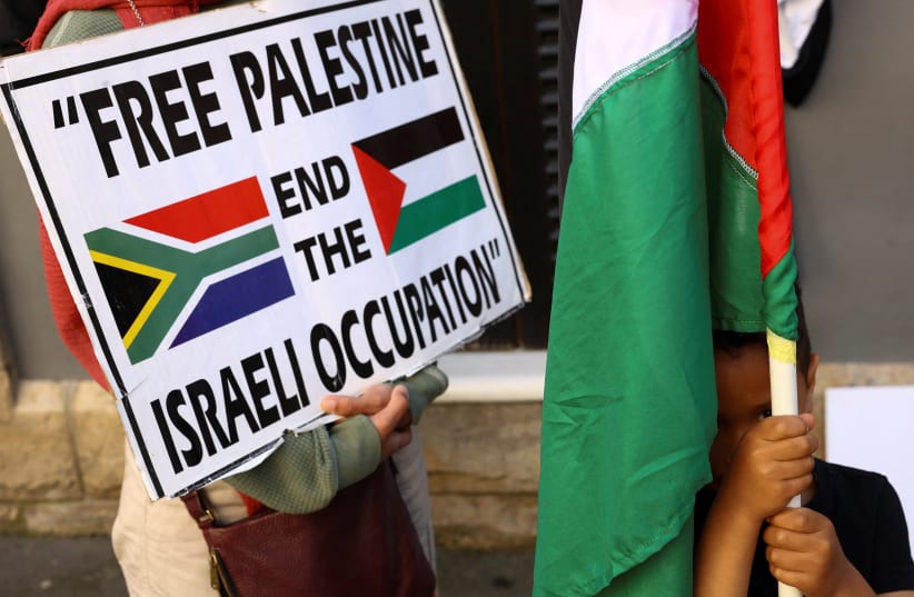  A boy holds a Palestinian flag during a demonstration to express support for the people of Palestine, in Cape Town, South Africa, October 9, 2023. (photo credit: REUTERS/ESA ALEXANDER)