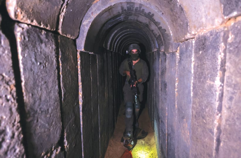  AN IDF soldier walks through a tunnel underneath Shifa Hospital in Gaza City, in November. (photo credit: RONEN ZVULUN/REUTERS)