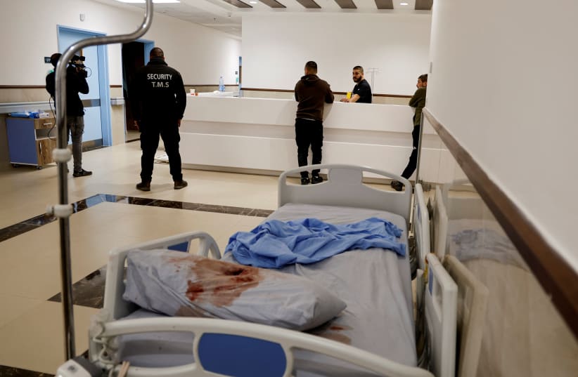  A blood-stained pillow lies on a bed at the site where three Palestinians were killed during an Israeli raid, at a hospital in Jenin, in the Israeli-occupied West Bank, January 30, 2024 (photo credit: REUTERS/RANEEN SAWAFTA)