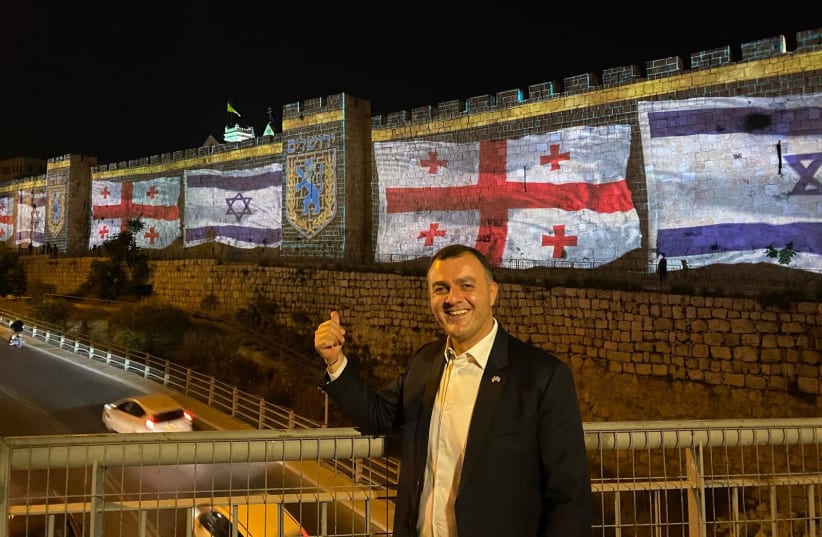  Georgian ambassador Lasha Zhvania in Jerusalem against backdrop of Georgian and Israeli flags (photo credit: COURTESY GEORGIAN EMBASSY)