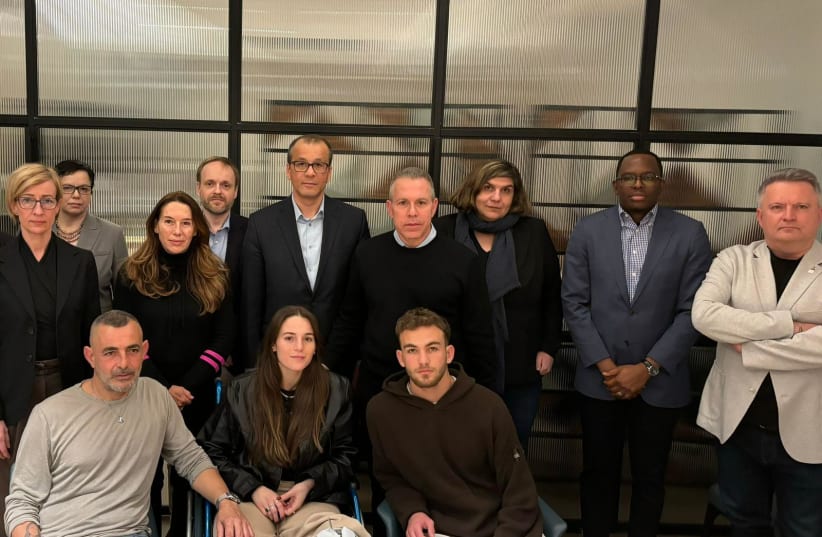  Released hostages Mia and Itai Regev with their father Itai (bottom) with a delegation of UN officials in Israel, including Gilad Erdan, after the Regev siblings spoke of their captivity in Gaza. (photo credit: Via Maariv)