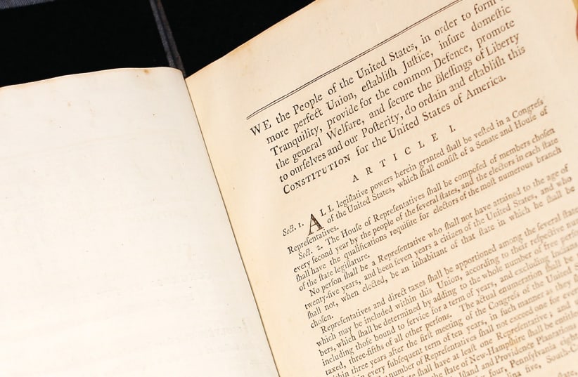  A book containing George Washington’s personal copies of the US Constitution and Bill of Rights, displayed at Christie’s auction house in New York. (photo credit: BRENDAN MCDERMID/REUTERS)
