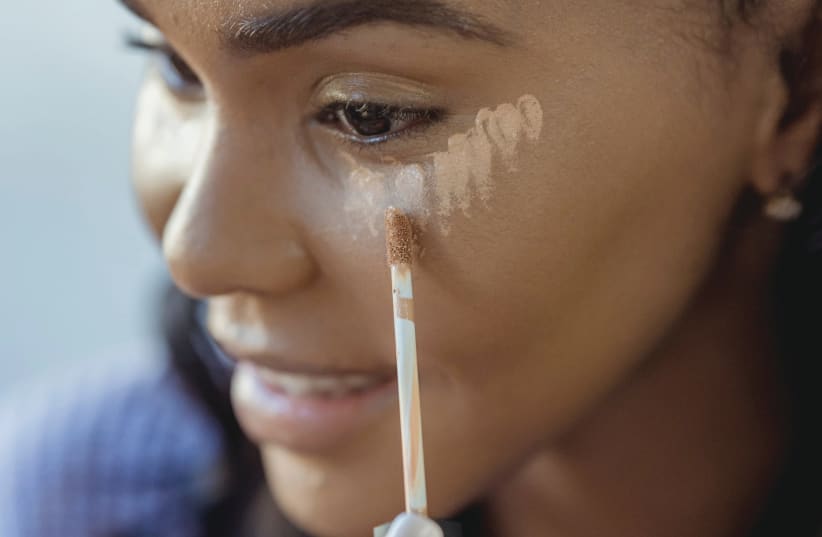  An illustrative photo of someone applying concealer. (photo credit: PEXELS)