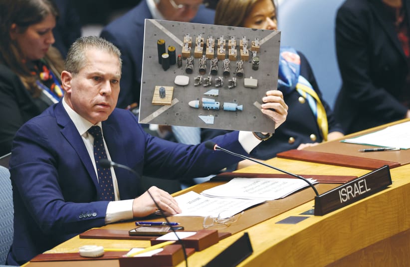  UNITED NATIONS Ambassador Gilad Erdan shows a picture of weapons found in Gaza by Israeli troops, at a United Nations Security Council meeting last month.  (photo credit: Charly Triballeau/AFP via Getty Images)