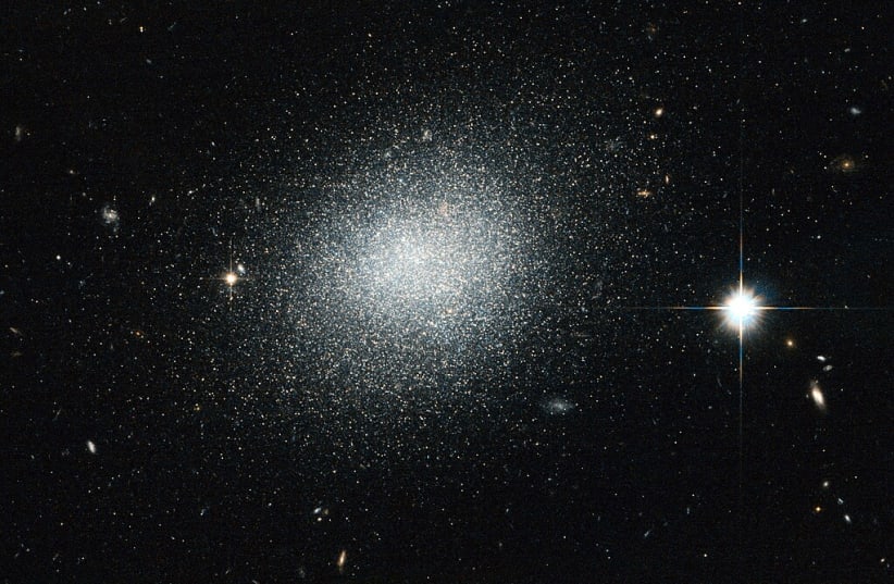  An illustrative image of a dwarf galaxy sitting in space. (photo credit: Wikimedia Commons)