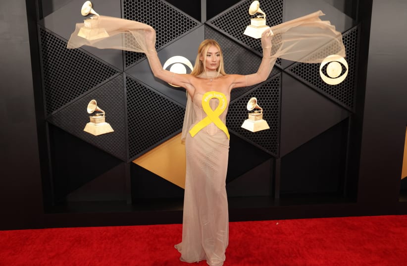  Montana Tucker poses on the red carpet as she attends the 66th Annual Grammy Awards in Los Angeles, California, US, February 4, 2024. Her outfit included a yellow ribbon symbolizing support for the 136 Israeli hostages held captive by Hamas in Gaza. (photo credit: REUTERS/MARIO ANZUONI)