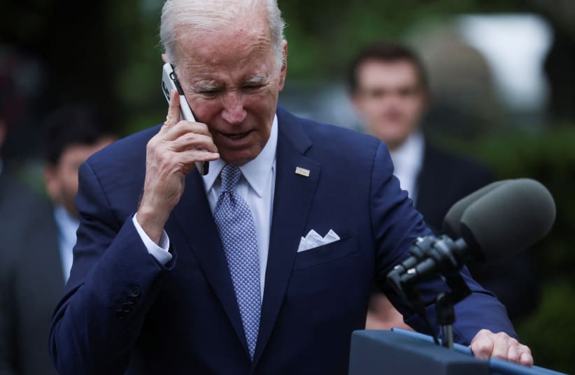  U.S. President Joe Biden speaks on a phone following an event marking National Small Business Week, in the Rose Garden of the White House in Washington, U.S., May 1, 2023. (photo credit: REUTERS/LEAH MILLIS)