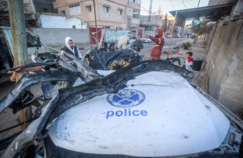  Palestinians at the site of a destroyed police car after it was hit from an Israeli airstrike in Rafah, on February 7, 2024 (photo credit: ATIA MOHAMMED/FLASH90)