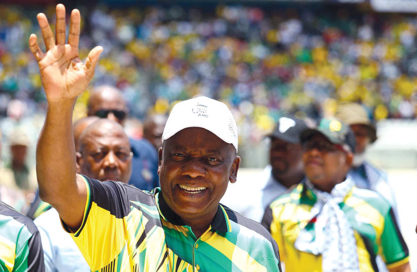  President of South Africa and of the African National Congress Cyril Ramaphosa waves to supporters as he arrives for the 112th anniversary celebrations of the founding of the party at Mbombela Stadium in Mpumalanga province, South Africa, on January 13.  (photo credit: SIPHIWE SIBEKO/REUTERS)