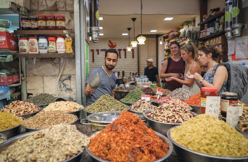  SHOPPING FOR ‘a few staples’ in Jerusalem’s Mahaneh Yehuda market. (photo credit: NATI SHOHAT/FLASH90)