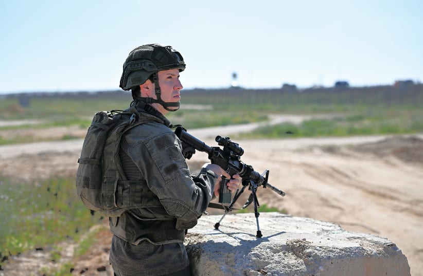 A SOLDIER stands guard near the Kerem Shalom crossing this week (photo credit: DYLAN MARTINEZ/REUTERS)