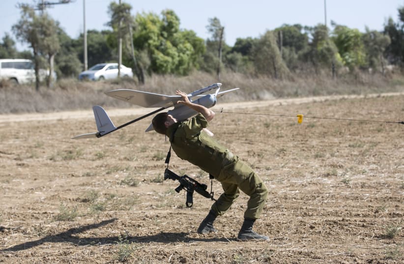  An Israeli soldier launches a Skylark unmanned aerial vehicle near the Israeli-Gaza Border July 16, 2014. (photo credit: REUTERS/BAZ RATNER)