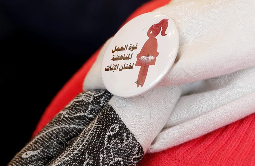  A badge reads "The power of labor aginst FGM" is seen on a volunteer during a conference on International Day of Zero Tolerance for Female Genital Mutilation (FGM) in Cairo, Egypt February 6, 2018. (photo credit: Amr Abdallah Dalsh/Reuters)